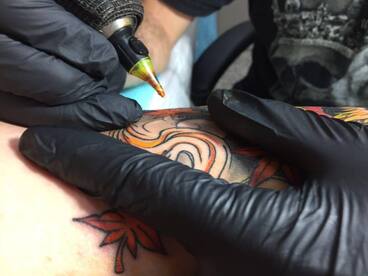 tattooing closeup chris cosmos needle ink tattoo machine