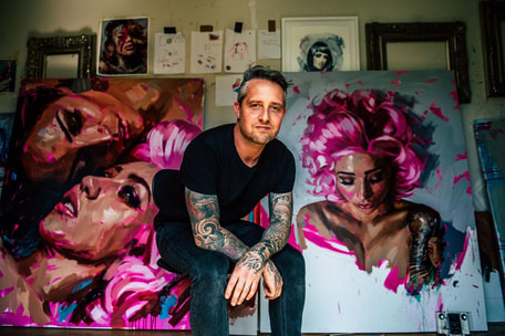 Chris Guest tattoo painter with some of his latest works of pinup models